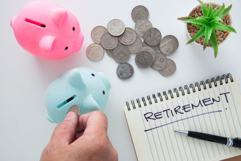 A woman placing a coin into a piggy bank representing retirement savings strategies