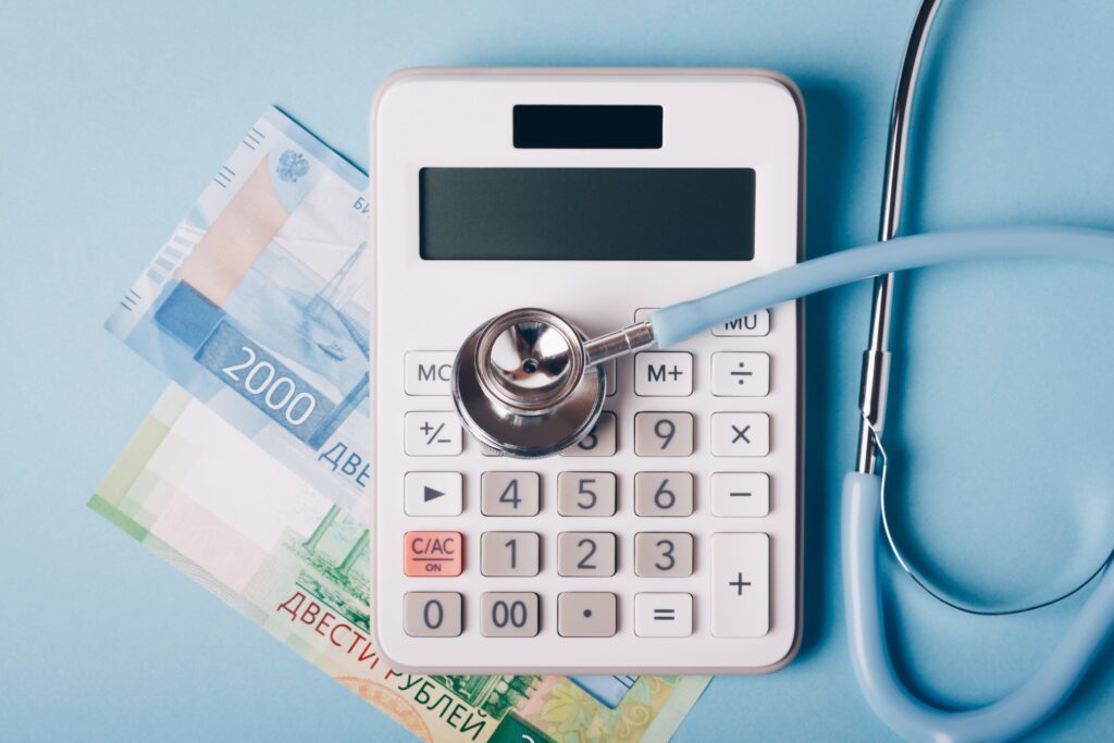 A stethoscope and calculator representing healthcare financial planning and HSA strategy